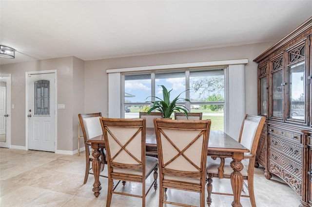 dining area with a healthy amount of sunlight and baseboards