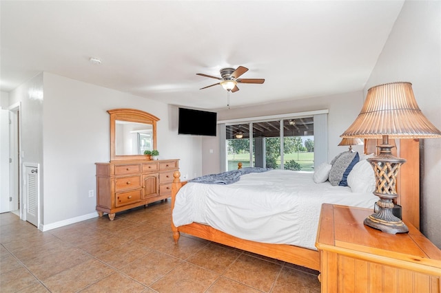 tiled bedroom with access to exterior, ceiling fan, and baseboards