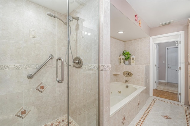 full bath with a stall shower, a jetted tub, visible vents, and tile patterned floors