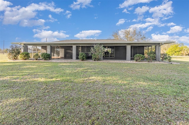 mid-century modern home with a sunroom and a front lawn