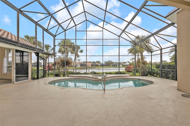 view of swimming pool with glass enclosure, a patio area, and a pool with connected hot tub