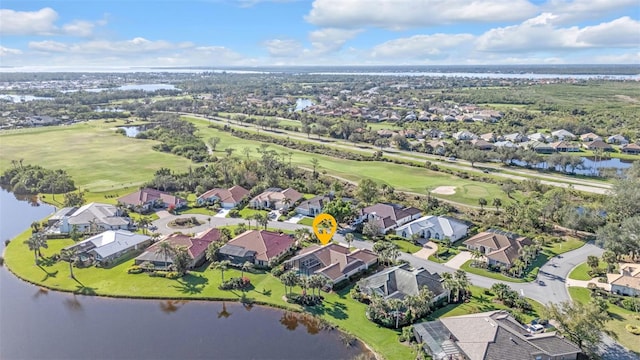 birds eye view of property with a water view and a residential view