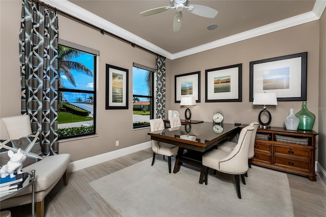 office area with a ceiling fan, crown molding, baseboards, and wood finished floors