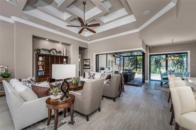 living area featuring a high ceiling, coffered ceiling, crown molding, and ceiling fan with notable chandelier