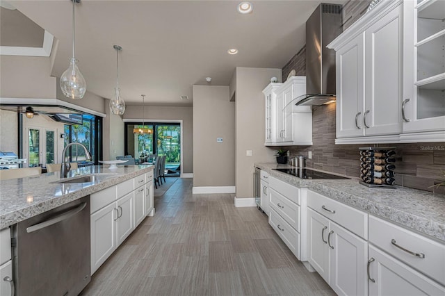 kitchen featuring a sink, white cabinetry, stainless steel dishwasher, backsplash, and wall chimney exhaust hood