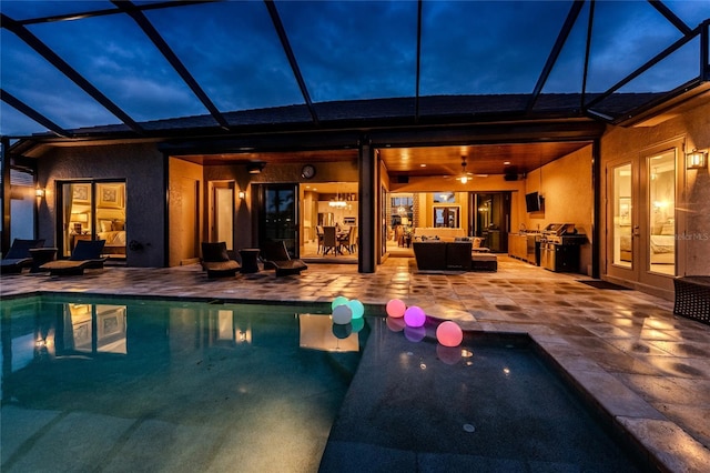 pool at twilight featuring an outdoor pool, french doors, outdoor lounge area, and a patio