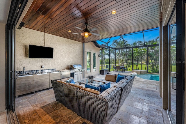 view of patio / terrace with a lanai, an outdoor living space, a ceiling fan, french doors, and grilling area