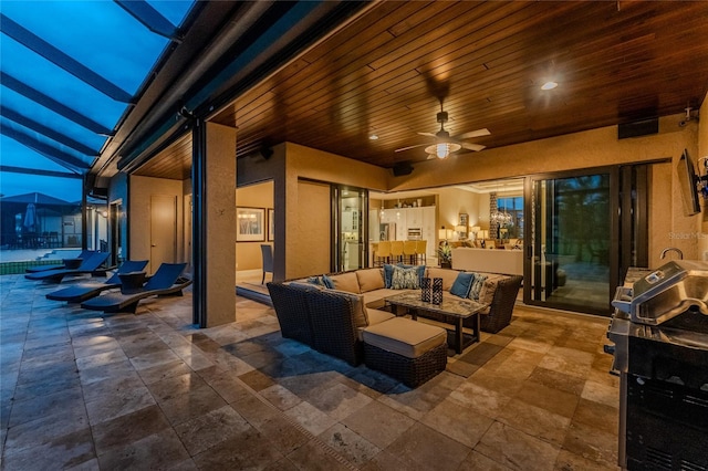 view of patio / terrace featuring a pool, glass enclosure, an outdoor living space, and a ceiling fan