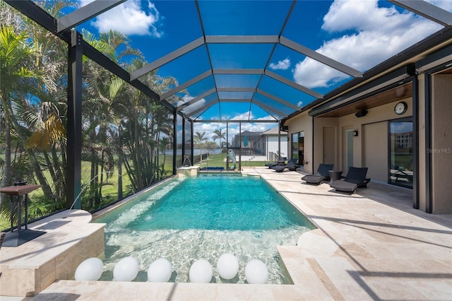 outdoor pool featuring a patio area and glass enclosure