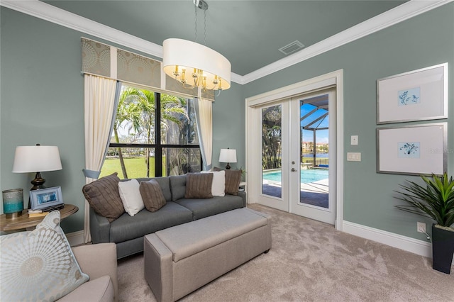 carpeted living room featuring visible vents, baseboards, ornamental molding, french doors, and a chandelier