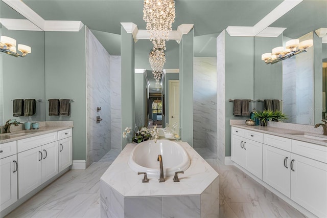 bathroom with marble finish floor, a garden tub, and a sink