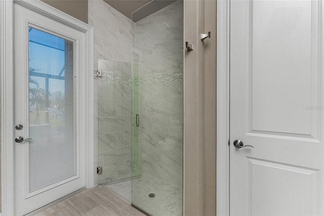 full bath featuring a marble finish shower