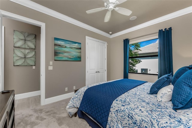 carpeted bedroom with ornamental molding, a ceiling fan, and baseboards