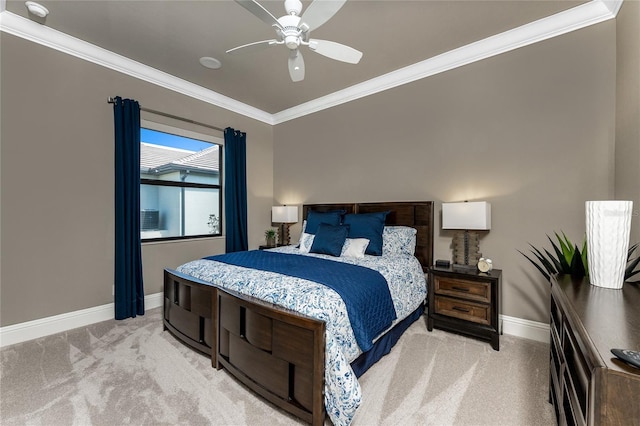 bedroom featuring light colored carpet, crown molding, baseboards, and ceiling fan