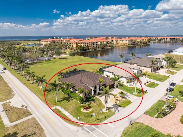 bird's eye view featuring a water view and a residential view