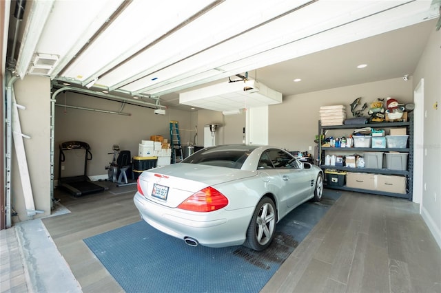 garage featuring a garage door opener and baseboards