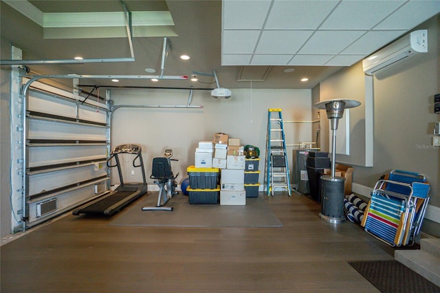 garage with a wall mounted air conditioner and baseboards