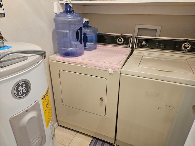 washroom featuring light tile patterned floors and washing machine and dryer