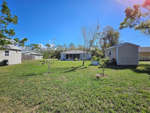 view of yard featuring a sunroom and fence