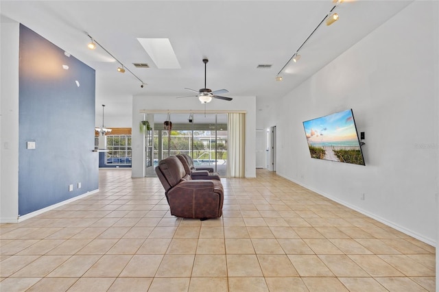 living area with a skylight, rail lighting, and visible vents