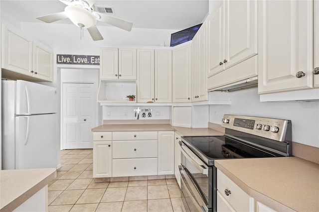 kitchen with visible vents, open shelves, under cabinet range hood, stainless steel range with electric cooktop, and freestanding refrigerator