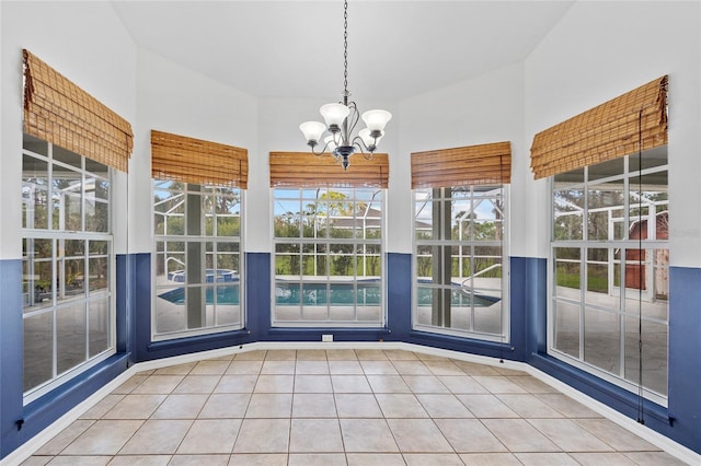 interior space with tile patterned flooring and a notable chandelier