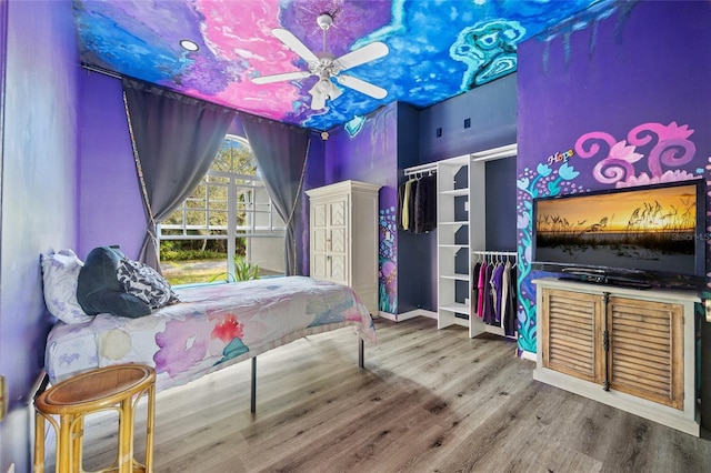 bedroom with ceiling fan and wood finished floors