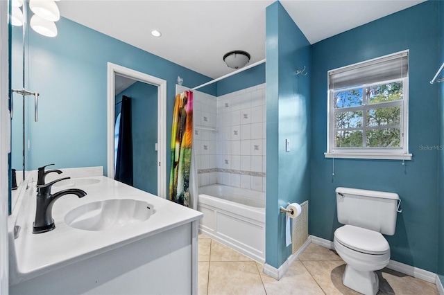 full bathroom featuring tile patterned floors, toilet, a sink, shower / tub combo, and baseboards