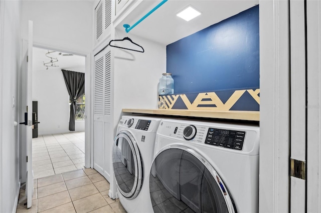 laundry area with light tile patterned flooring, laundry area, and washer and dryer