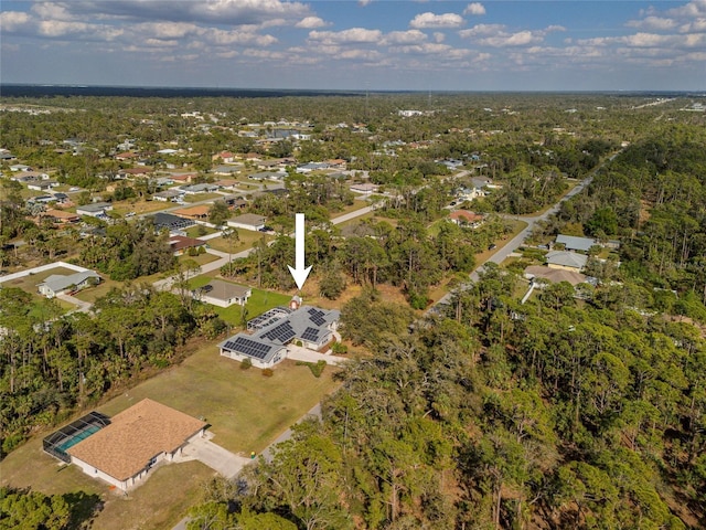 drone / aerial view with a wooded view