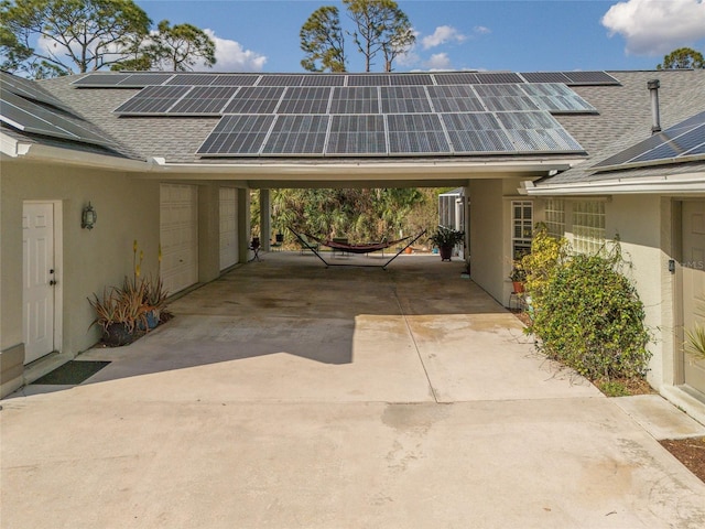 view of parking with a carport and concrete driveway