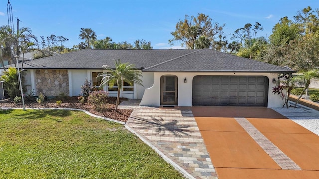 view of front of home featuring stucco siding, a shingled roof, an attached garage, a front yard, and driveway