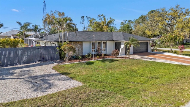 single story home featuring an attached garage, fence, concrete driveway, stone siding, and a front lawn