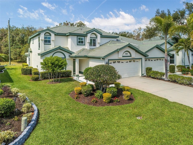 view of front of property featuring stucco siding, driveway, a front lawn, a tile roof, and a garage