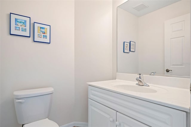 bathroom with visible vents, toilet, and vanity