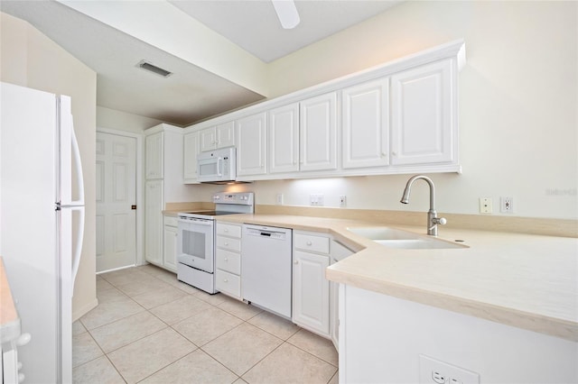 kitchen with white appliances, visible vents, light tile patterned flooring, a sink, and white cabinetry