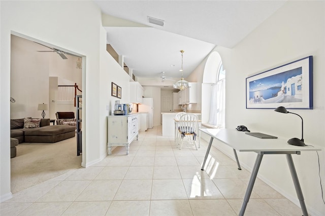 hallway featuring visible vents, light carpet, baseboards, and light tile patterned flooring