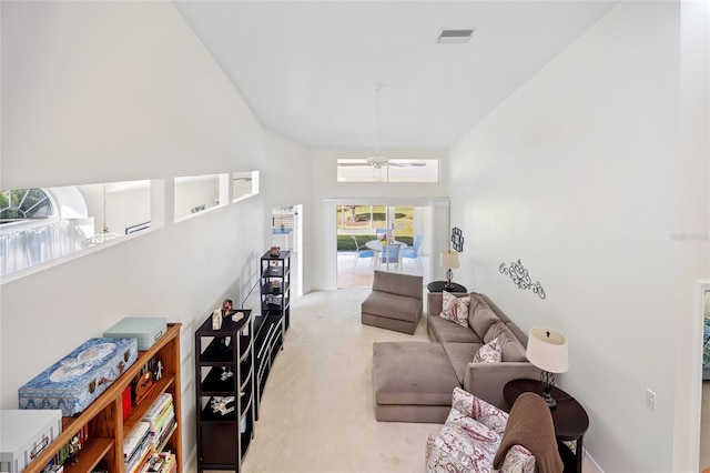 carpeted living room with visible vents and ceiling fan