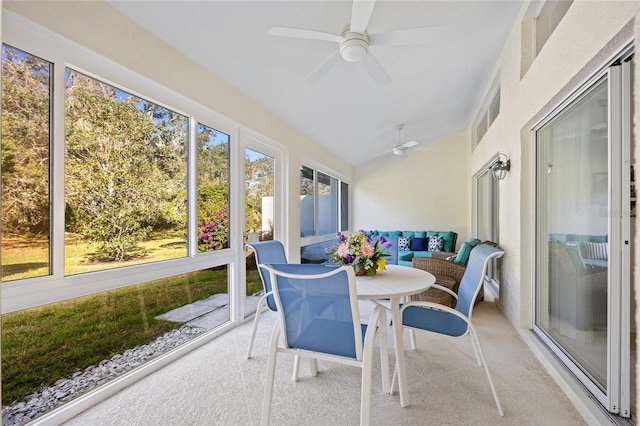 sunroom featuring vaulted ceiling, visible vents, and ceiling fan