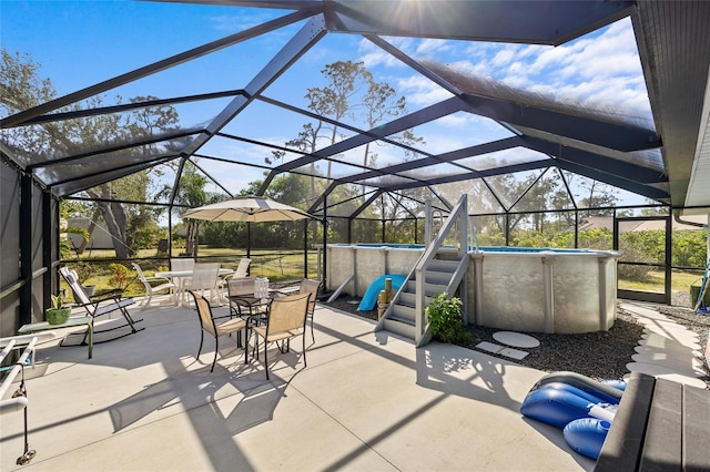 view of patio / terrace featuring glass enclosure, outdoor dining area, and an outdoor pool