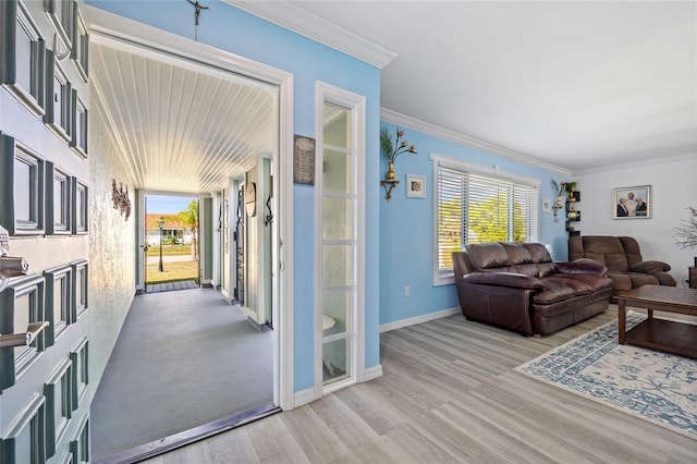 interior space with plenty of natural light, crown molding, baseboards, and wood finished floors