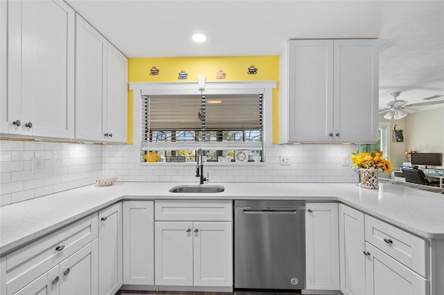 kitchen with a sink, stainless steel dishwasher, a wealth of natural light, and white cabinetry