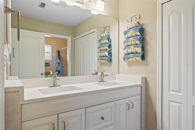 bathroom with double vanity, visible vents, a shower with shower curtain, and a sink