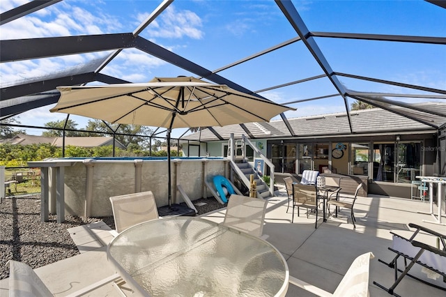 view of patio / terrace featuring an outdoor pool, outdoor dining area, and a lanai