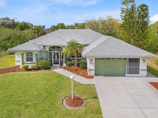 ranch-style house with a front yard, an attached garage, stucco siding, a shingled roof, and concrete driveway