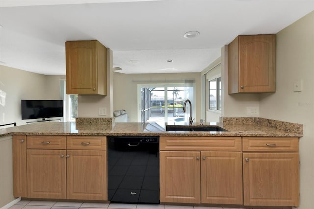 kitchen with a sink, a peninsula, light stone counters, and dishwasher