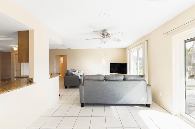 living area featuring light tile patterned floors and ceiling fan