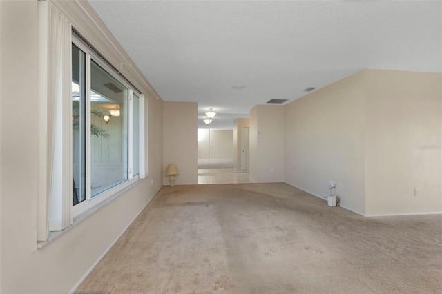 spare room featuring carpet floors and visible vents