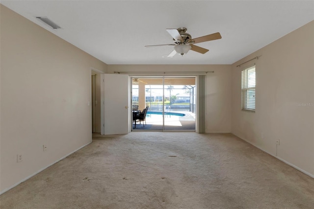 spare room with a ceiling fan, a sunroom, visible vents, and carpet flooring