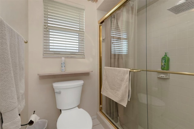 bathroom with a stall shower and toilet